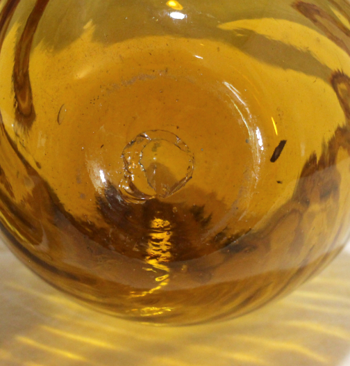 Amber glass vase, ribbed swirl, folded rim